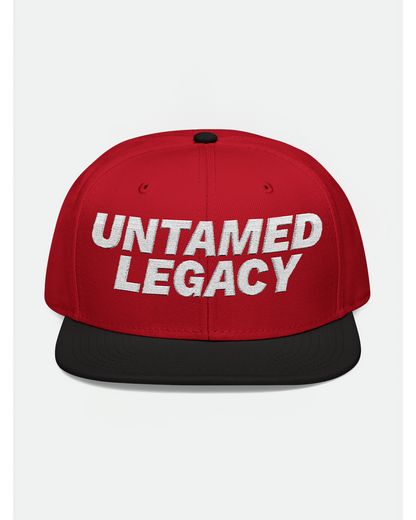 Bold red and black snapback hat with white embroidered “Untamed Legacy” logo, designed for standout streetwear styling.