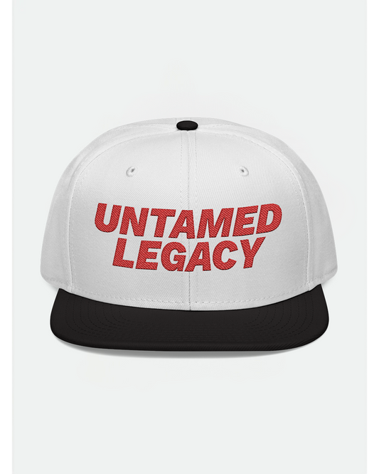 White snapback hat with contrasting black brim and bold red embroidered “Untamed Legacy” logo — a timeless urban essential.